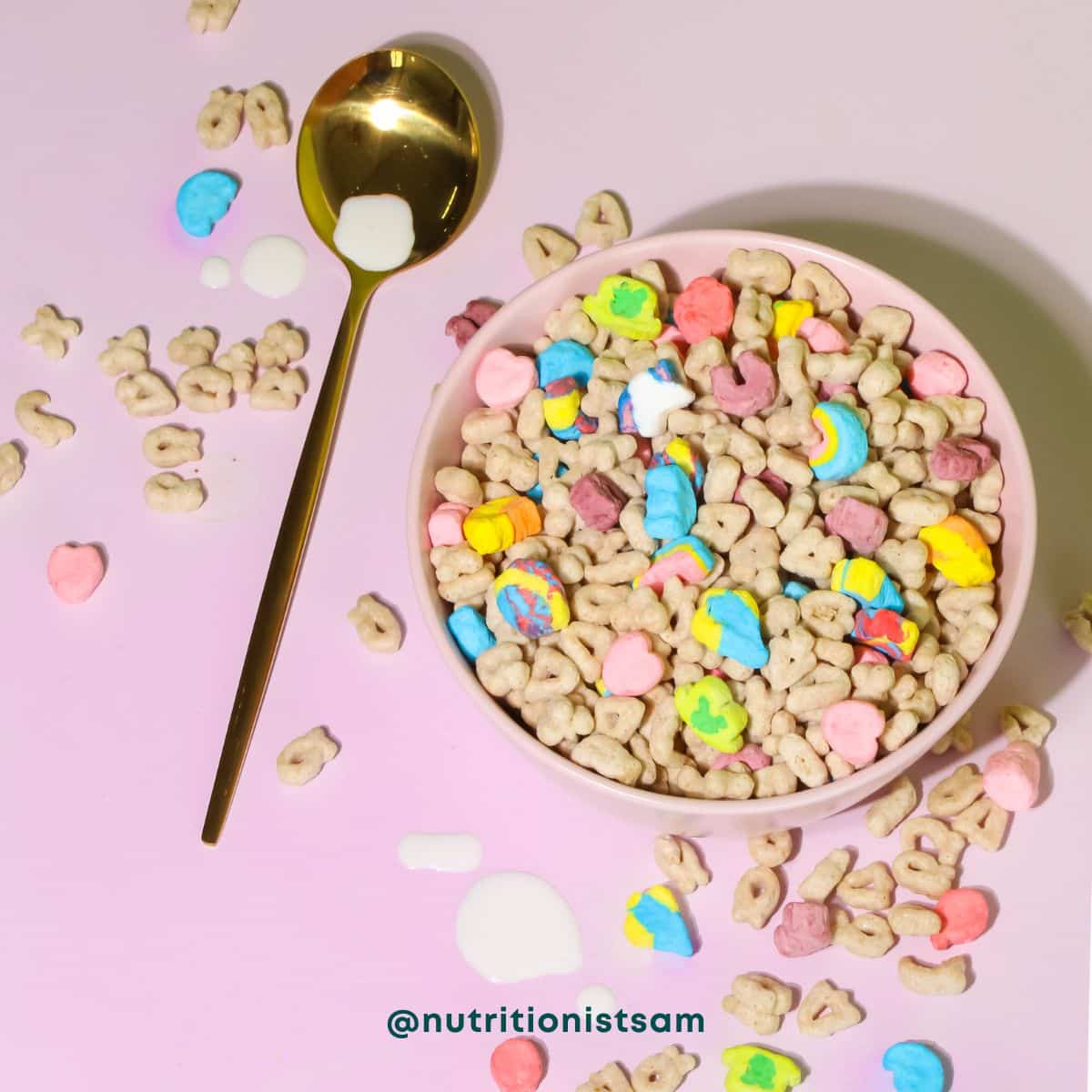 Pink background with pink bowl filled with cereal and milk