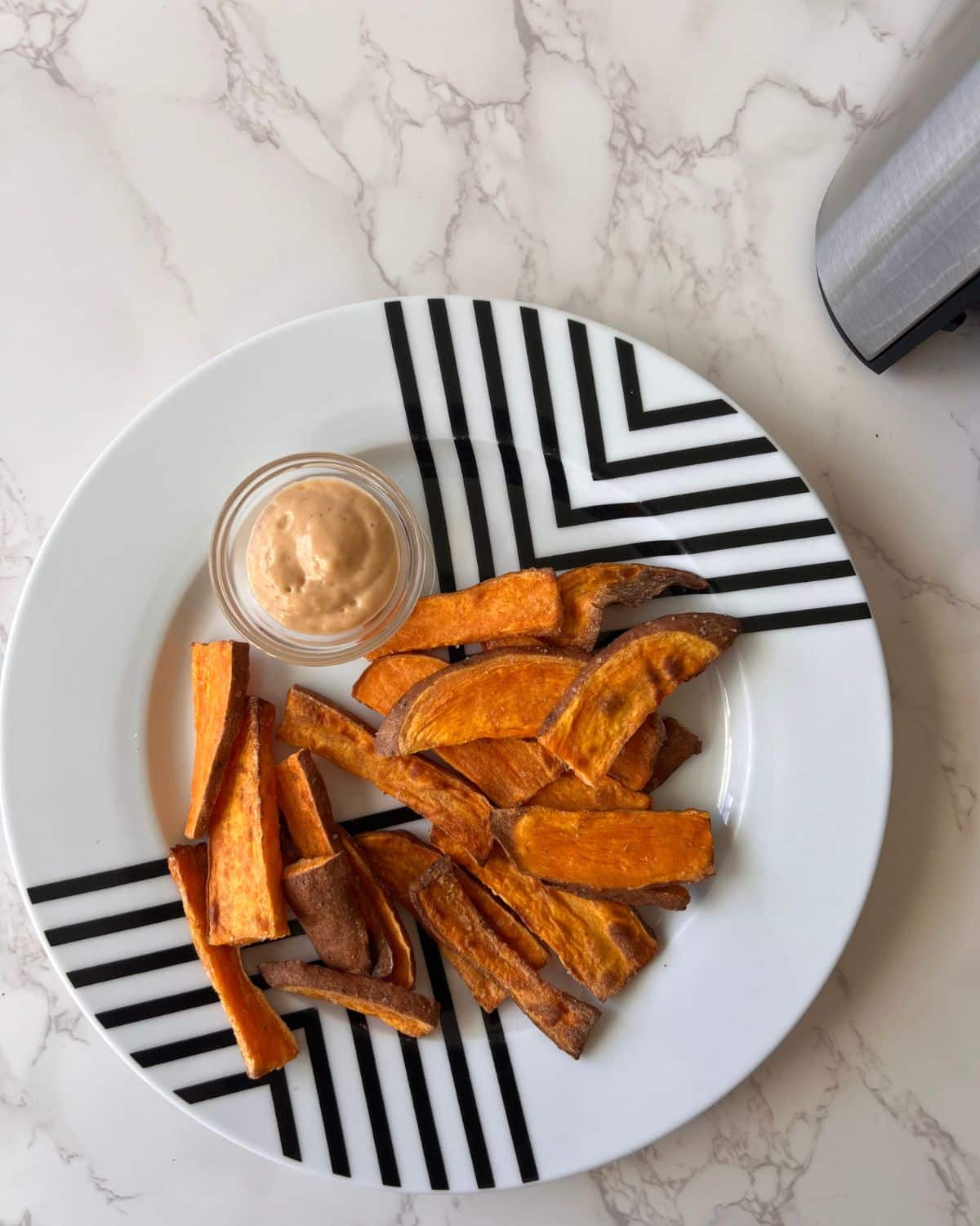 Image of a black and white plate with air fryer sweet potato wedges
