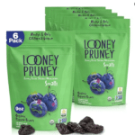 Image of multiple packages of organic looney pruneys in green pouches are must have travel snacks